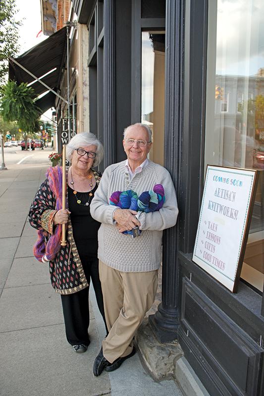 Sandra VanBurkleo and Larry Hart, owners of Artisan Knitworks stand outside of the Main Street building in Chelsea.